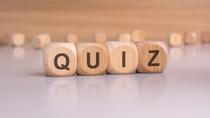 wooden blocks with text quiz, brawn background