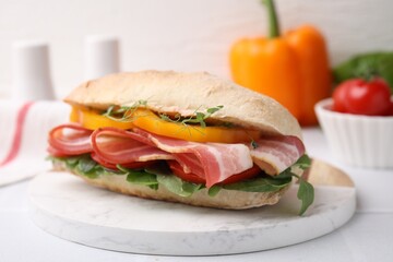 Tasty sandwich with bacon and bell pepper on white table, closeup