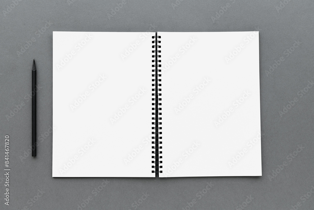 Poster opened notebook page with a black pencil design element