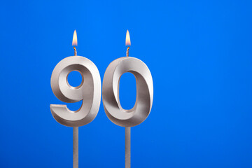 Birthday candle number 90 - Celebration card on blue background