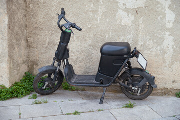 Black moped parked on the street