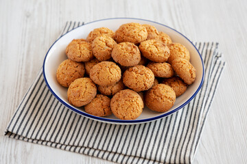 Homemade Sweet and Crunchy Amaretti on a Plate, side view.