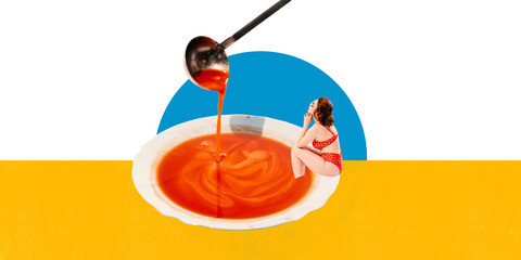 Elegant young woman in red polka-dot swimsuit sitting inside large bowl of tomato soup. Relaxing....