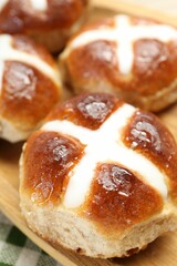 Tasty hot cross buns on table, closeup