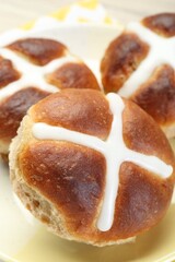 Tasty hot cross buns on table, closeup