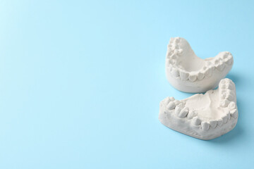 Obraz premium Dental model with gums on light blue background, space for text. Cast of teeth