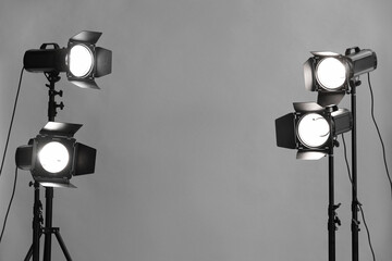 Grey photo background and professional lighting equipment in studio