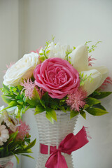 Interior compositions with bouquets of flowers in vases in a flower shop. Decorative modern artificial flowers.
