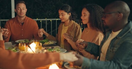 Friends, holding hands and pray, food and worship together, gratitude and thanks to God at dinner party. Men, women and diversity with nutrition and religion, celebration and social event at night