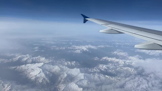 Aerial View of Airbus Wing Over Majestic Swiss Alps - Scenic Flight Above Snow-Capped Mountains