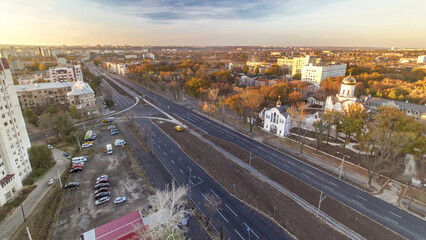 Aerial vivid colorful sunset view with road traffic skyscape timelapse. Kharkiv city from above