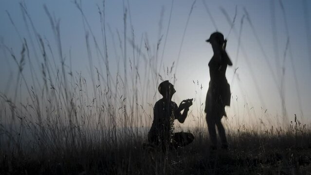Romantic man proposing to a woman in the park