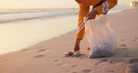 Volunteer, beach and plastic cleaning or pollution in nature or community service, garbage or waste management. Person, climate change and ocean litter pickup as recycle, global warming or future © N Lawrenson/peopleimages.com