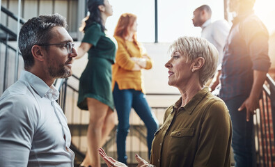 Staff, business people and discussion on stairs in office for feedback, progress and consult with...