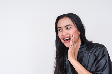 Pretty asian woman in black silk bathrobe sharing exciting news