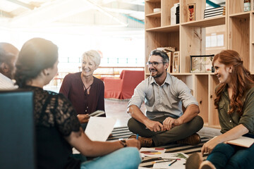 Group, circle or business people sitting on floor for collaboration, documents and notes for ideas. Teamwork, huddle or meeting with leader for company plan, talking with graph for strategy in office