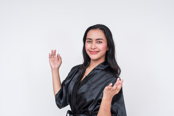 Pretty Asian woman in black silk bathrobe feeling peaceful