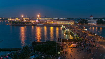 Naklejka premium Night view of spit of Vasilyevsky Island and Birzhevoy Bridge with rostral column timelapse, Saint Petersburg, Russia.
