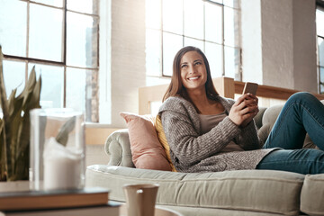 Sofa, smile and woman with phone in house for social media, notification and communication. Happy, relax and person thinking with tech in living room for internet, connection and update on blog
