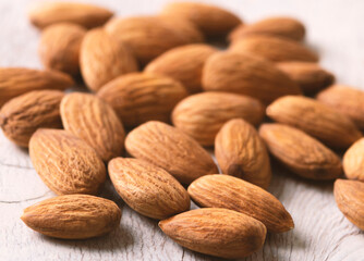 Almonds on wihte wooden background.Organic nuts.