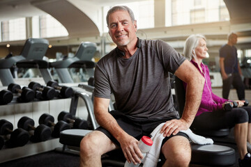 Obraz premium Fitness, music and portrait of old man in gym with water bottle for training, exercise and workout. Sports, retirement and person with listening to music, audio and radio for wellness, rest or health