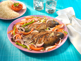 Grilled fish attieke, afrikanische Küche, gegrillter Fisch, Reis, Zwiebeln, Tomaten, 
