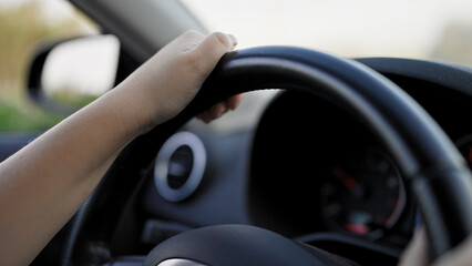 Young beautiful hispanic woman driving a car on the road