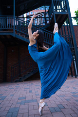 Obraz premium Beautiful Asian ballerina dancing outdoors. Urban landscape.