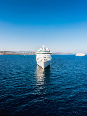 Cruise ship at Akrotiri bay sailing away on calm blue sea © kirill_makarov