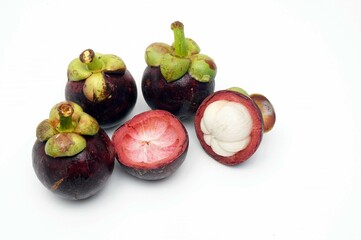 A lot of a fresh mangosteens just peeled just keep from the tree in gardens.	
