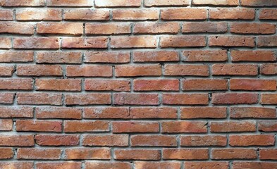 A texture and backgrounds a holizontal vintage red brick wall.