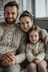 Obraz premium Caucasian family father, mother and little daughter child wearing beie clothes embracing