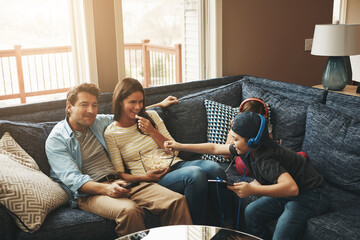 Family, children and parents on sofa, watching tv or streaming with tablet for bonding in living...