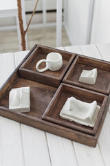 Rustic Wooden Serving Tray with White Ceramicware on a Bright Interior Setup