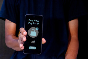 Man using a smart phone for online shopping with payment later. Buy now pay later online shopping concept.