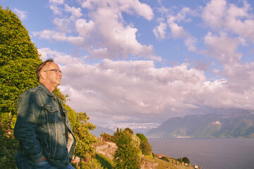 Man tourist admiring vneyard terraces on Lake Geneva in summer, Lavaux, Vaud, Switzerland