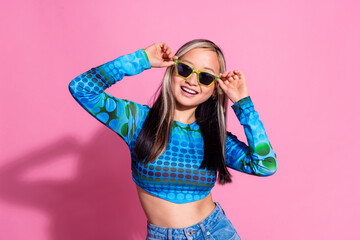 Photo of shiny attractive lady dressed print shirt dark eyewear smiling empty space isolated pink color background