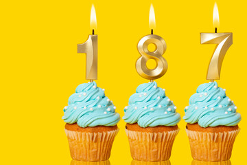 Birthday Cupcakes With Candles Lit Forming The Number 187