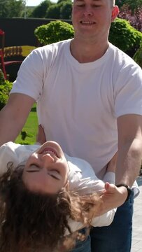 Guy and girl dance beautifully bachata in city center Kharkiv, Ukraine Several couples in jeans and T-shirts dance in nature