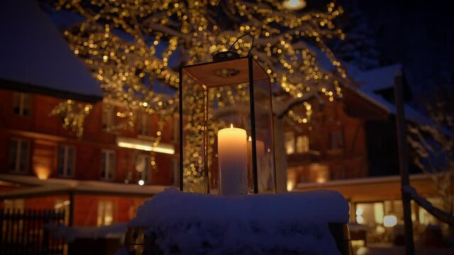 Cozy Winter Evening with Candle Lantern and Festive Lights creating a warm and inviting ambiance