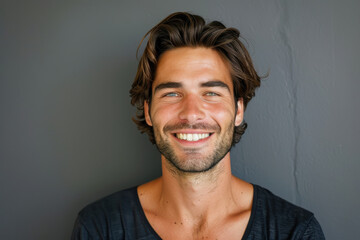 Obraz premium A close up portrait of a young man with a subtle smile