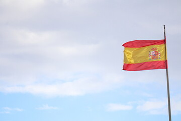 Spanish flag in the cloudy sky. waving in the sky