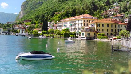 Boats docked in front of luxury houses at Lake Como
