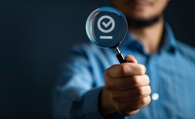 A businessman holding a virtual magnifying glass with a checkmarked person icon, a human resources concept, for team selection or selection when team employees work. Acceptance concept