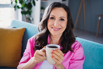 Photo of lovely cute senior woman enjoying weekend vacation drinking fresh hot tea comfy indoors