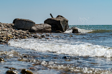 A splash of water on the stones at a beach