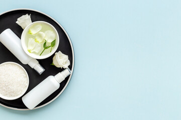 White roses and stones with skin care cosmetics products. Mock up, top view