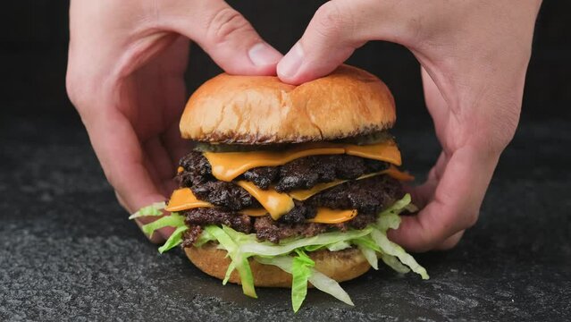 Taking  Smash burger with lettuce, cheddar cheese and sauce