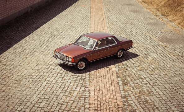Brown classic Mercedes-Benz W123 coupe from 1970s. Three quarter view from above of brown old car. Kyiv region, Ukraine - July 18 2015.