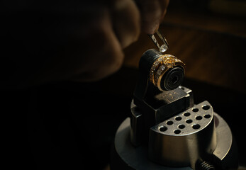 craftsman making diamond ring. hand made jewelery. Put diamond gem ring. diamond ring production. hand made in craftsman workshop close up. black background.